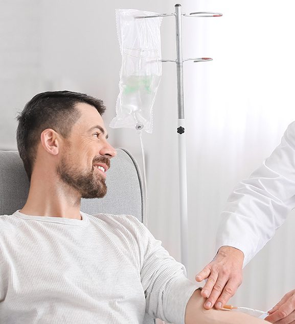 Man receiving an IV vitamin drip