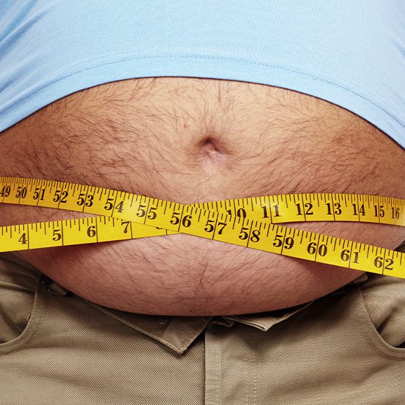 Man measuring his stomach