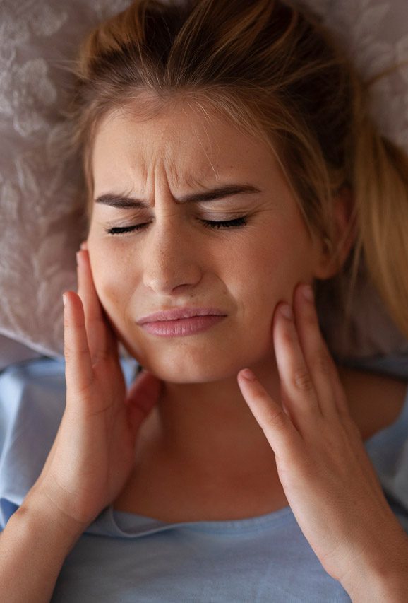 Woman holding her face