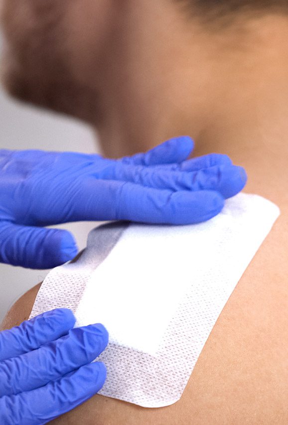 person with gauze pad on shoulder