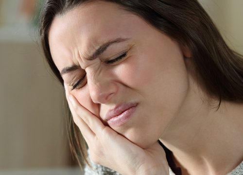 Woman suffering from TMJ