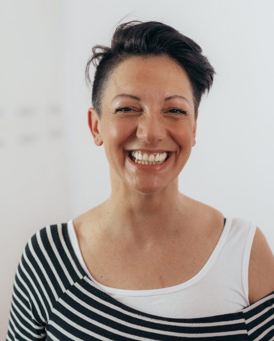 Photo of a smiling woman with short, dark hair