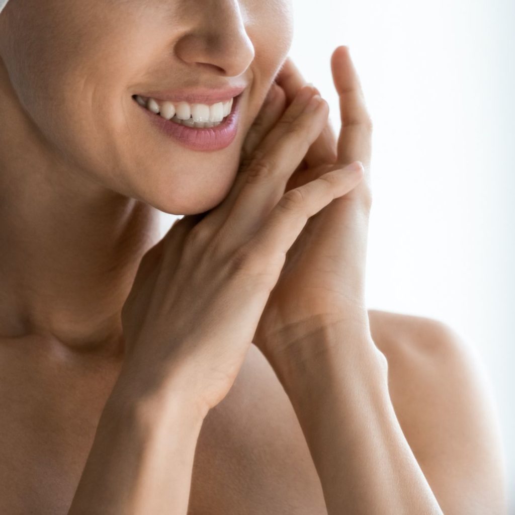 Photo of a smiling woman with focus on her hands