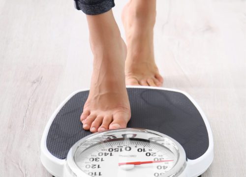 Woman stepping on a scale